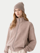 Woman wearing a beige jacket and beanie on a white background. #color_taupe #ai-image