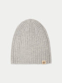Gray knit beanie with a brand tag on a light gray background #color_light-gray