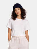 Person wearing a white t-shirt and navy headband on a plain background. #color_navy #ai-image