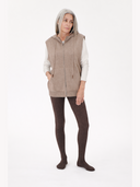 Woman wearing a beige zip-up hoodie and brown tights on a white background. #color_deep-mole