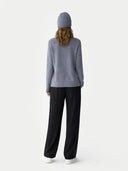 Person wearing a grey jumper and black pants on a white background #color_black