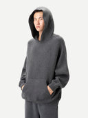 Person wearing a gray hoodie on a white background. #color_dark-gray