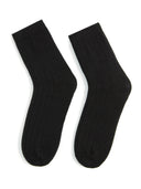 A pair of black unisex cashmere trim knit bed socks. #color_black