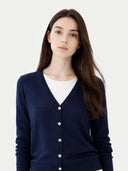 Woman wearing a navy blue cardigan over a white shirt on a white background #color_navy-blue