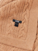 Close-up of a cable-knit sweater with a Gobi label. #color_light-brown