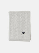 Gray cable knit blanket with a brand label on a white background. #color_steel-silver