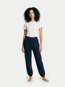 Person wearing navy blue pants and a white shirt on a white background
#color_ink-blue
#ai-image