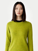 Woman wearing a green jumper on a white background #color_white