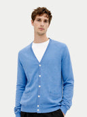 Man wearing a blue cardigan over a white shirt on a light gray background. #color_blue #ai-image