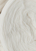 Close-up of undyed natural colour cashmere yarn wound into a pale cream skein