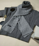 Men's cashmere gifts flat lay with grey cable knit roll neck jumper and matching scarf