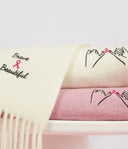 Embroidered cashmere scarf and knits marking breast cancer awareness month, pink ribbon and pinky promise detail