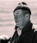 Black and white portrait of a herder in a knitted hat, illustrating Mongolian nomadic life