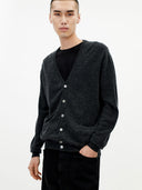 Man wearing a dark gray cardigan over a black shirt on a white background. #color_charcoal