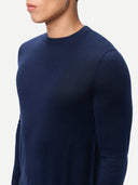 Navy blue sweater worn by a person on a light gray background. #color_dark-indigo