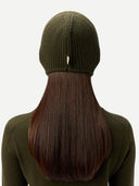Person wearing a green knit beanie with long brown hair styled in a ponytail.