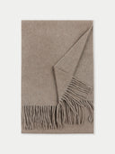 A fringed scarf in beige, with a geometric pattern and a tassel detail.