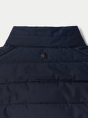 Navy blue puffer vest with a brand logo on a light gray background
