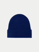 A rib-knitted blue beanie hat. #color_deep-cobalt