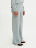 A person standing wearing gray wide-leg silk cashmere pants with an elasticated waist and a mid-rise cut. #color_abyss
