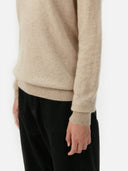 Beige sweater worn by a person on a white background. #color_soft-beige