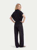 Woman wearing a black outfit on a white background