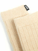Pair of beige socks with a brand label on a white background #color_beige