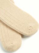 Pair of beige socks on a white background #color_beige