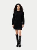 Woman wearing a black dress and black boots on a white background. #color_black #ai-image
