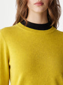 Yellow sweater worn by a person on a white background. #color_celery-green #ai-image