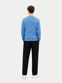 back view of a man wearing a blue sweater and black pants on a white background. #color_blue #ai-image