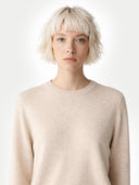 Person wearing a beige sweater against a white background. #color_light-beige #ai-image