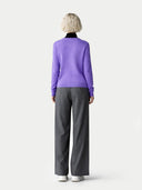 back view of a woman wearing a purple sweater and gray pants on a white background. #color_purple #ai-image