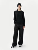 Person wearing a black outfit on a white background