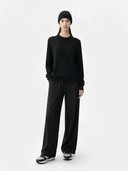 Person wearing a black outfit on a white background #color_black