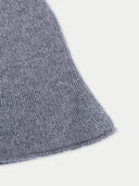 Close-up of a textured gray fabric corner on a white background