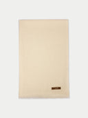 Beige blanket with a brand label on a white background #color_off-white