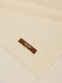 Beige blanket with a brown tag displaying 'Gobi' on a beige background #color_off-white