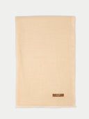 Beige scarf with a brand label on a white background