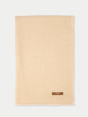 Beige scarf with a brand label on a white background #color_beige