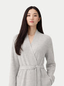 Woman wearing a gray robe against a white background. #color_steel-silver #ai-image