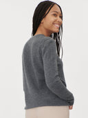 Woman wearing a gray sweater on a white background. #color_dark-gray