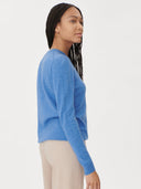 Woman wearing a blue sweater on a white background. #color_blue