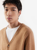 Man wearing a brown cardigan over a white shirt on a white background. #color_light-brown