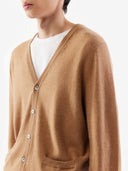 Brown cardigan worn by a person on a white background. #color_light-brown