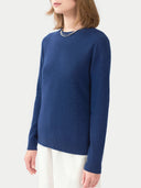 Person wearing a blue sweater on a white background. #color_insignia-blue