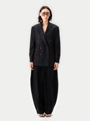 Person wearing a black suit with a white background #color_black