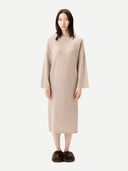 Woman wearing a beige dress on a white background
