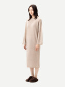 Woman wearing a beige dress on a white background