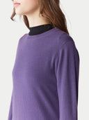 Purple sweater worn by a person on a white background. #color_dusty-grape